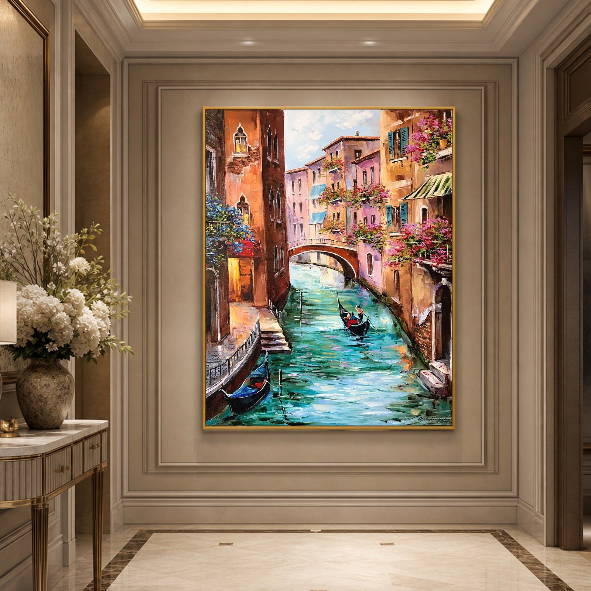 A framed canvas painting of a Venetian canal scene with gondolas, colorful buildings, and a bridge, displayed on a beige wall in an elegant interior hallway.