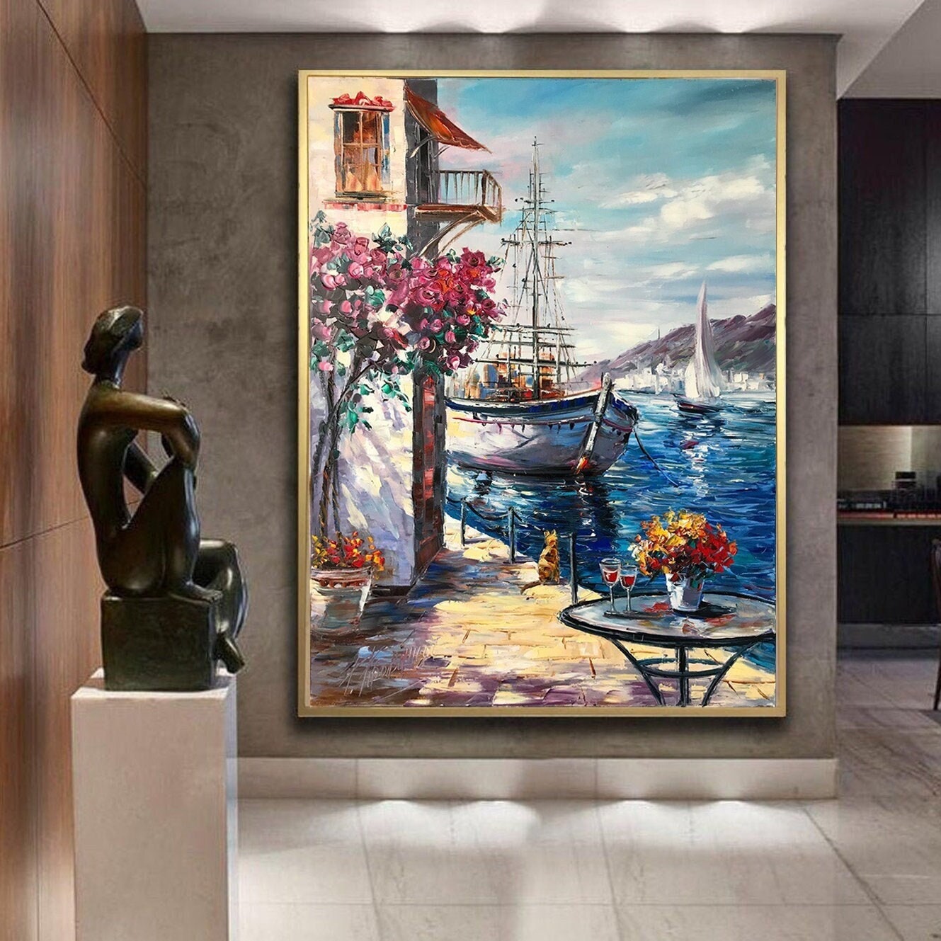 May include: A painting of a sailboat docked in a harbor with a building and flowers in the foreground. The sky is blue with white clouds and the water is a deep blue.